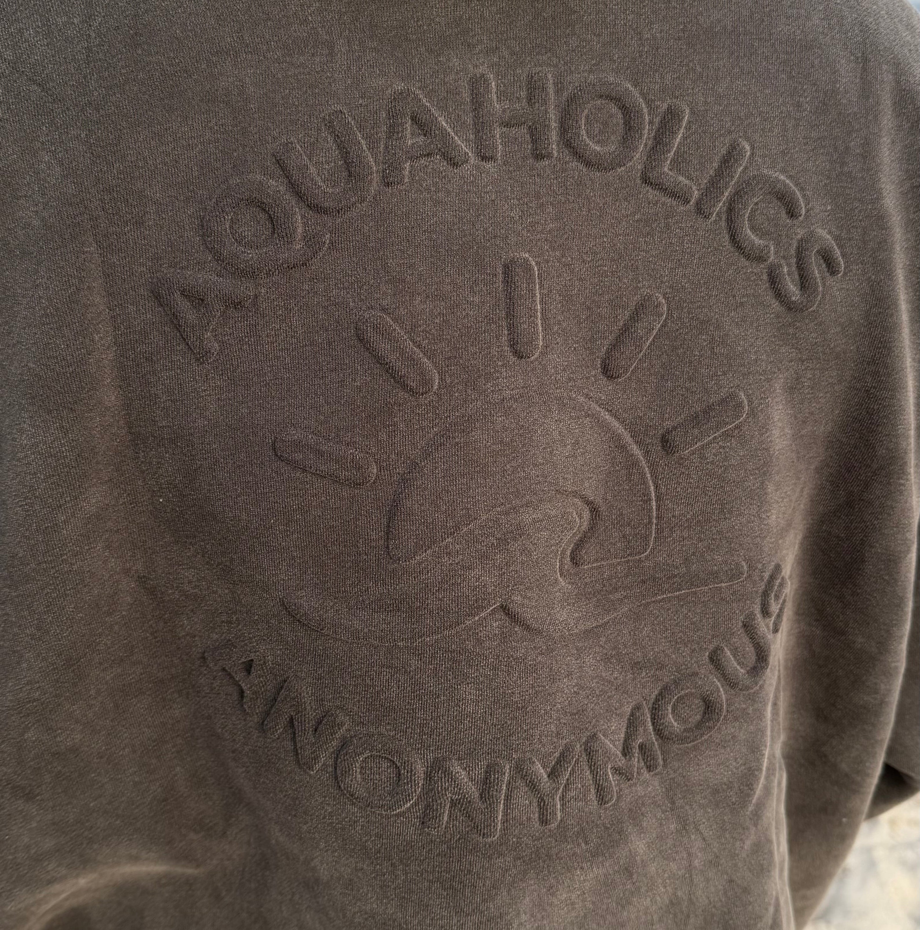 Close up of embossed detail Aquaholics Anonymous hoodie