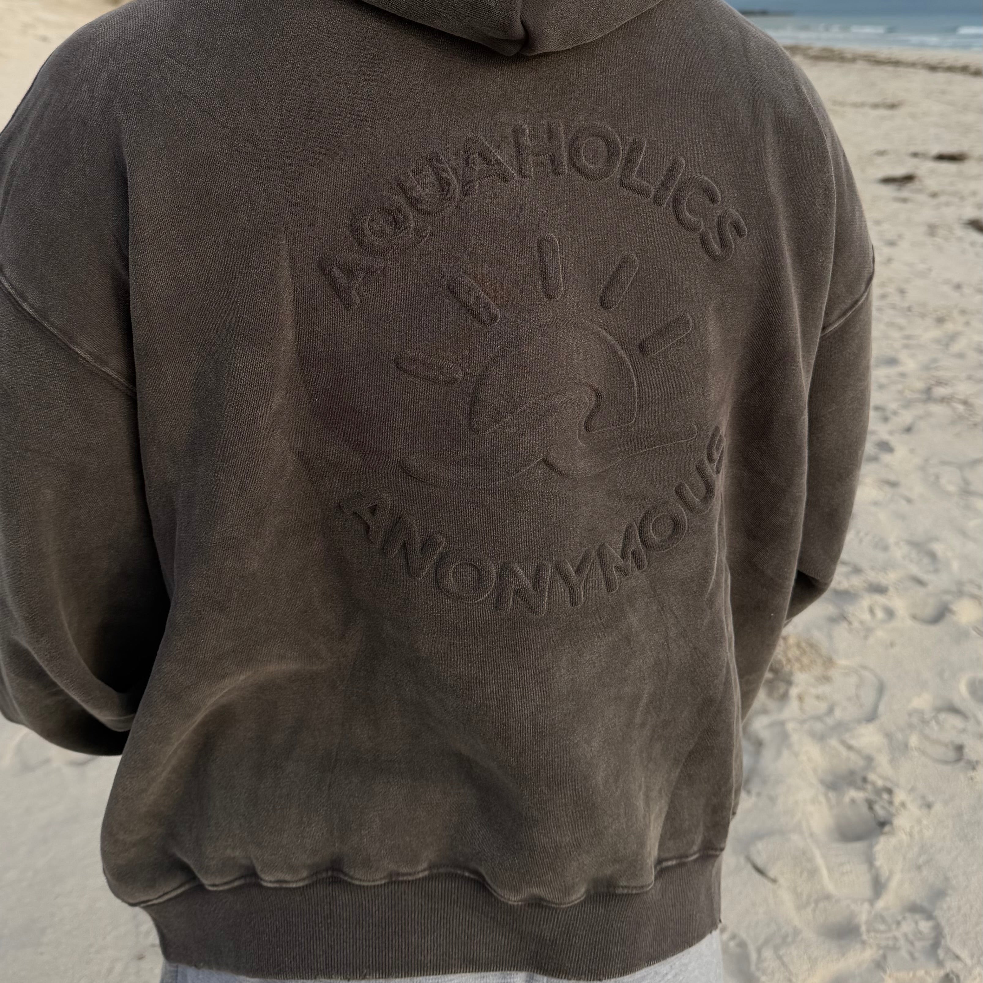 Close up detail of embossed  Aquaholics Anonymous hoodie